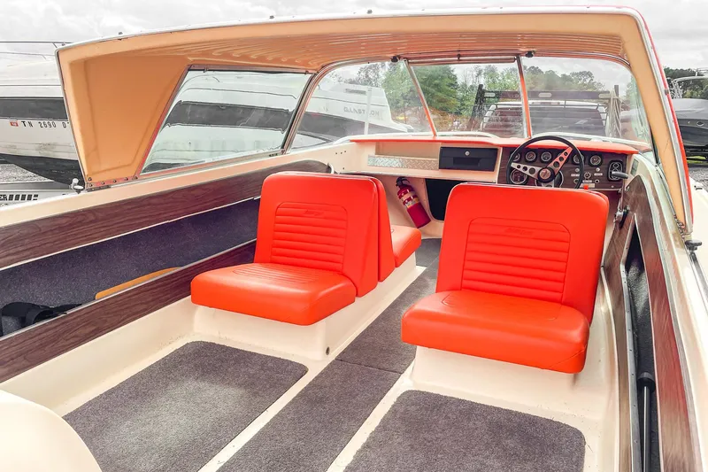 Slide: The Image of 1975 AristoCraft 19 boat interior with vibrant orange seats and classic dashboard. - 18