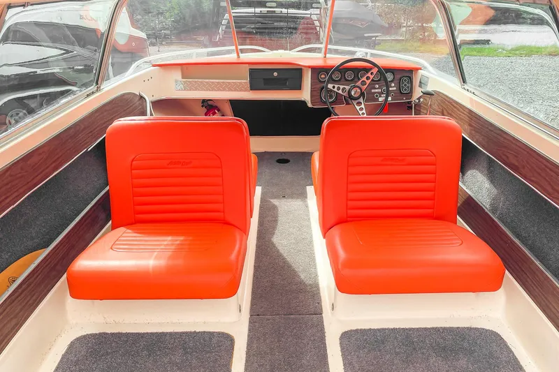 Slide: The Image of 1975 AristoCraft 19 boat interior with bright orange seats and classic dashboard. - 19