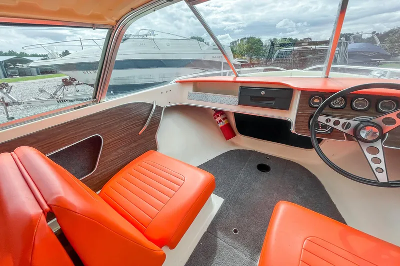 Slide: The Image of 1975 AristoCraft 19 boat interior with orange seats and vintage dashboard. - 22