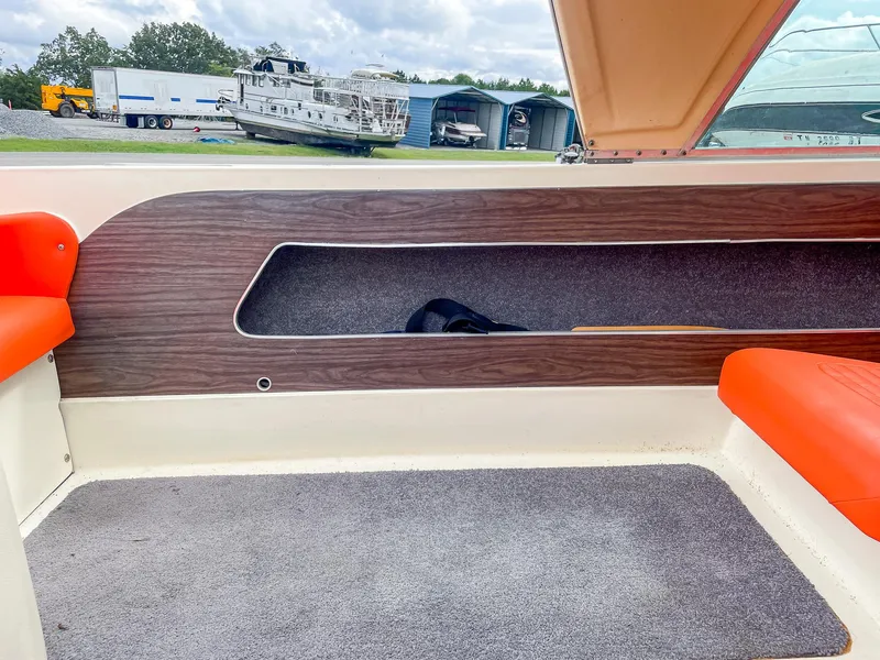 Slide: The Image of Interior of a 1975 AristoCraft 19 boat with orange seats and wood paneling. - 29