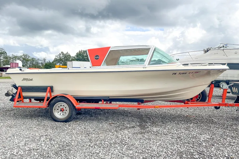 Slide: The Image of 1975 AristoCraft 19 boat on red trailer under cloudy sky. - 3