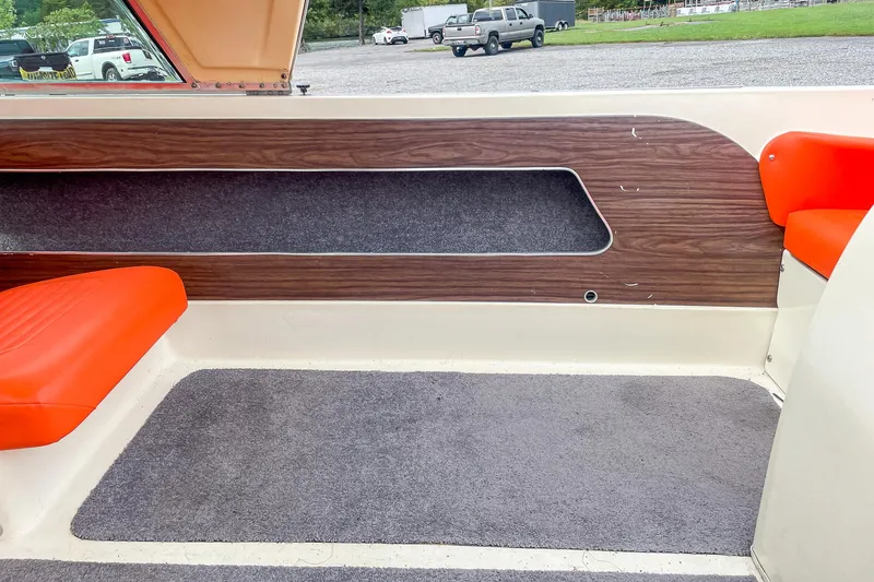 Slide: The Image of Interior of a 1975 AristoCraft 19 boat with orange seating and wood paneling. - 30