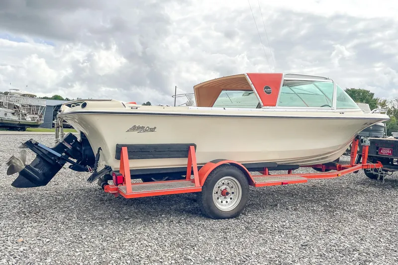 Slide: The Image of 1975 AristoCraft 19 boat on trailer, parked on gravel, under cloudy sky. - 4