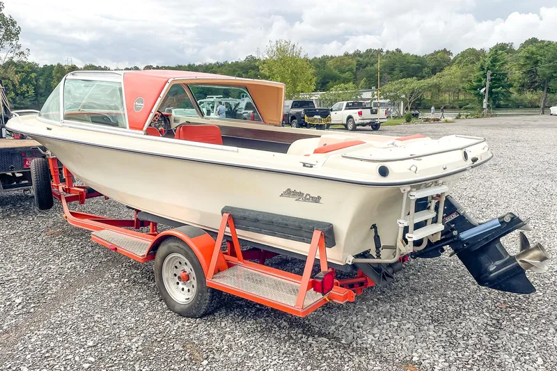 Slide: The Image of 1975 AristoCraft 19 boat on trailer in gravel lot. - 5