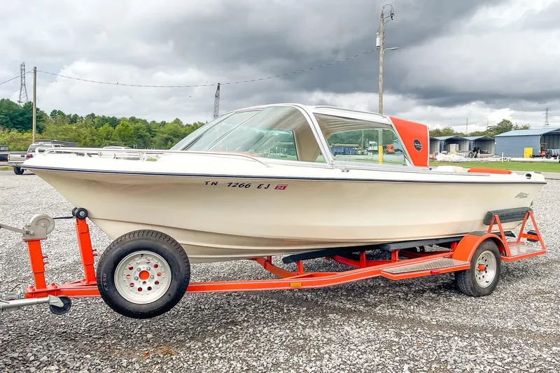Slide: The Image of 1975 AristoCraft 19 boat on red trailer under cloudy sky. - 7