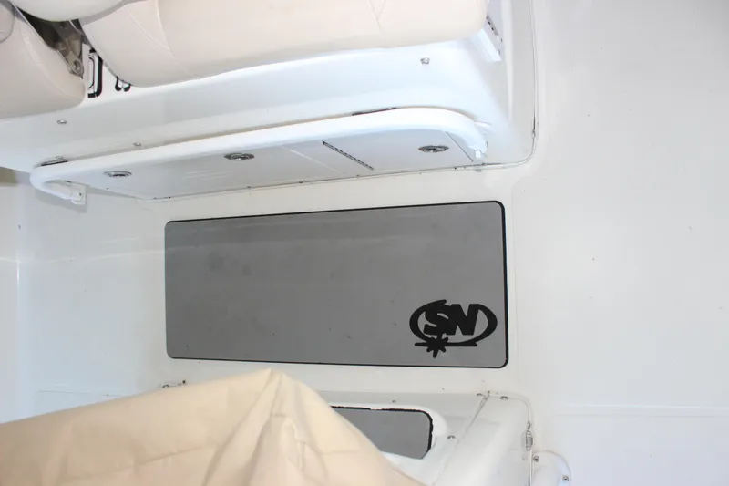 Slide: The Image of Interior of 2018 NauticStar 28 XS Offshore boat, featuring seating and storage area. - 10