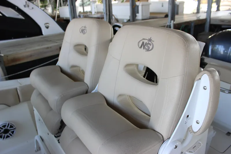 Slide: The Image of 2018 NauticStar 28 XS Offshore boat seats in beige upholstery. - 11