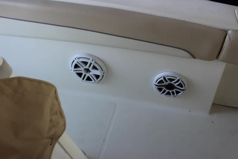 Slide: The Image of 2018 NauticStar 28 XS Offshore boat interior with speakers and seating. - 12