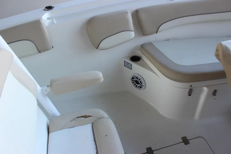 Slide: The Image of Interior seating of 2018 NauticStar 28 XS Offshore boat with beige cushions. - 14