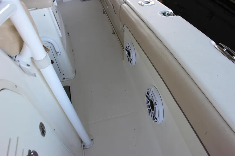 Slide: The Image of 2018 NauticStar 28 XS Offshore boat interior with speakers and seating. - 15