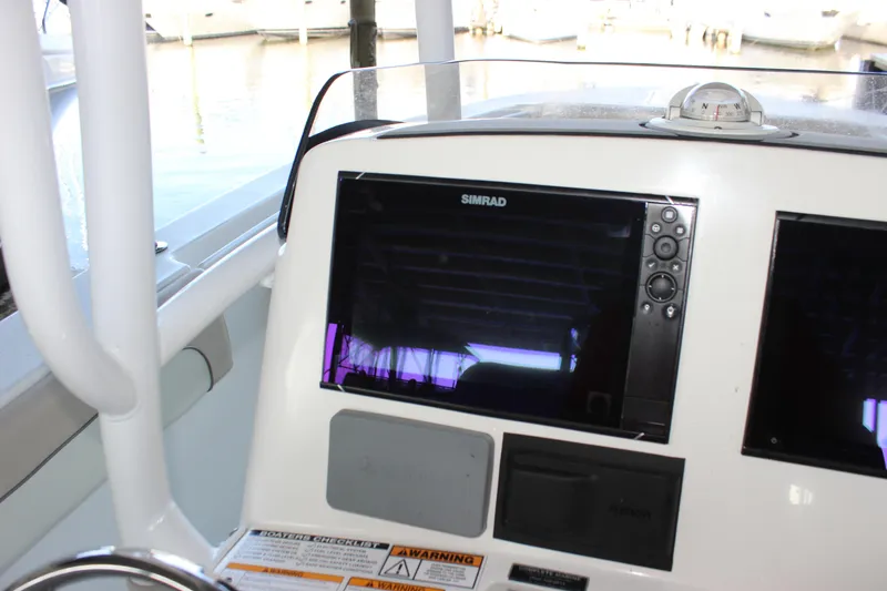 Slide: The Image of 2018 NauticStar 28 XS Offshore boat dashboard with Simrad navigation system. - 16