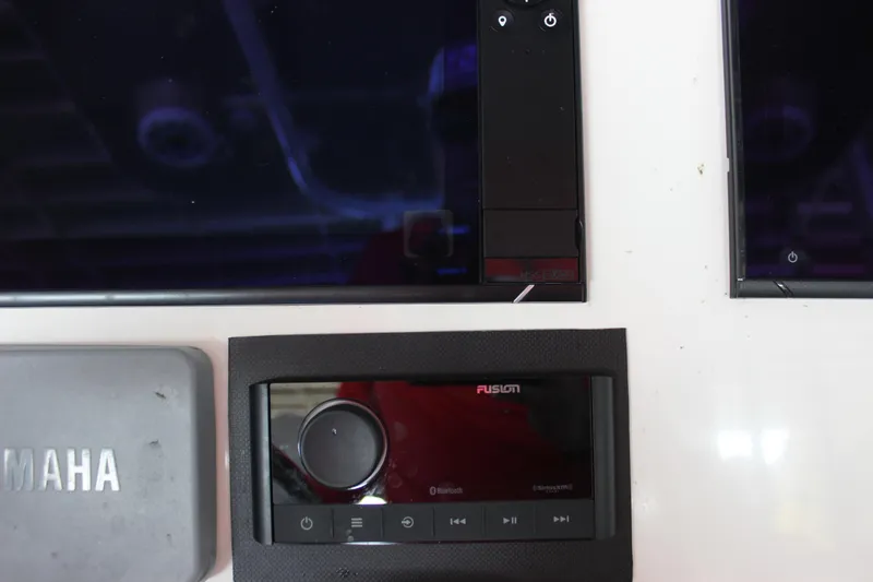 Slide: The Image of Fusion audio system on 2018 NauticStar 28 XS Offshore boat dashboard. - 18