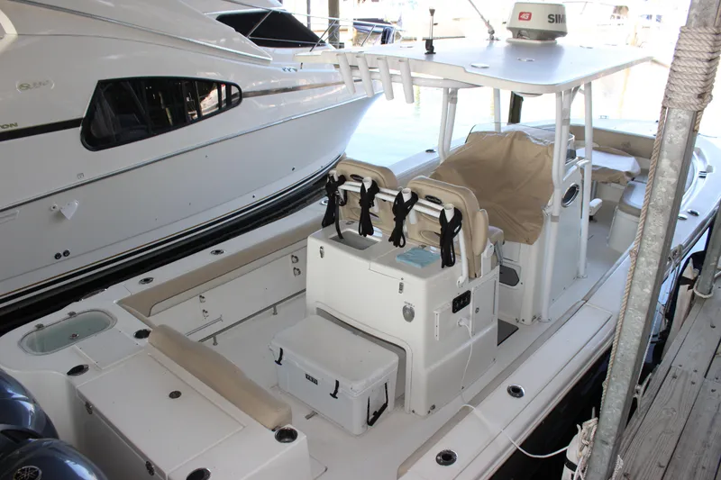 Slide: The Image of 2018 NauticStar 28 XS Offshore boat docked, featuring spacious seating and modern amenities. - 6