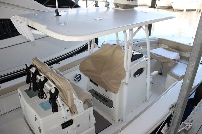 Slide: The Image of 2018 NauticStar 28 XS Offshore boat interior with seating and console. - 7
