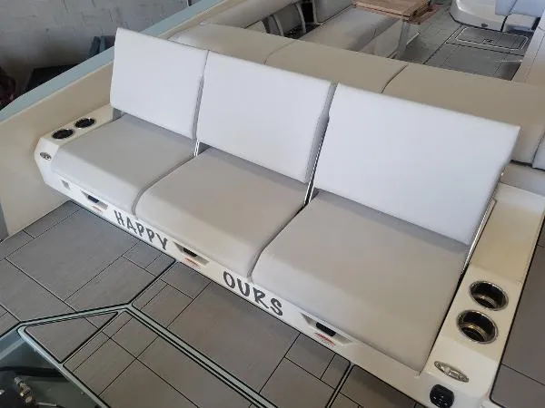 Slide: The Image of Aviara AV32 OB 2022 boat seating with "Happy Ours" text, featuring white cushioned seats. - 11