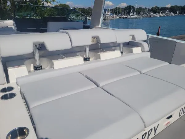 Slide: The Image of 2022 Aviara AV32 OB luxury boat with spacious seating, docked by a marina. - 12