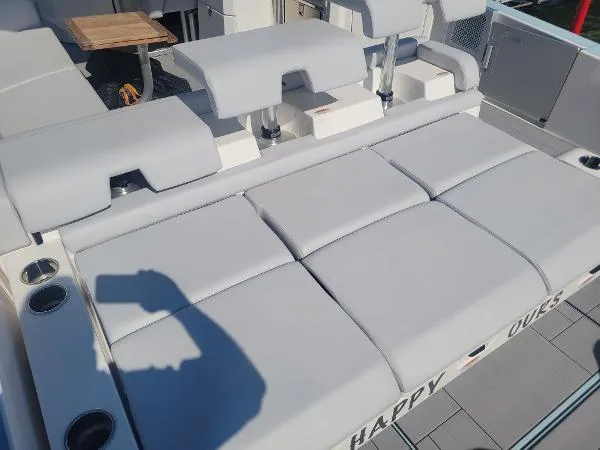 Slide: The Image of 2022 Aviara AV32 OB boat with spacious gray seating and cup holders. - 13
