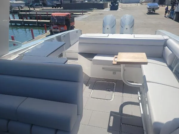 Slide: The Image of 2022 Aviara AV32 OB boat interior with seating and table, docked at marina. - 14