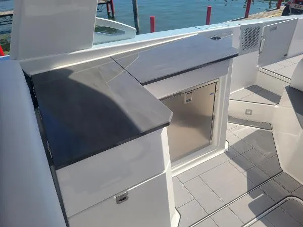 Slide: The Image of 2022 Aviara AV32 OB boat interior with sleek countertop and storage. - 16