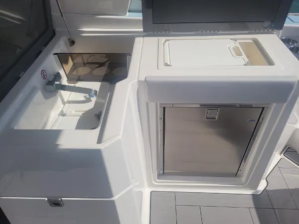 Slide: The Image of 2022 Aviara AV32 OB boat kitchenette with sink and storage. - 17