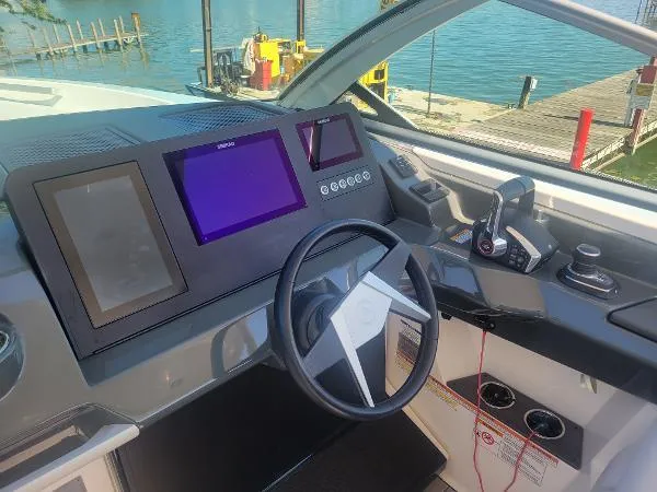 Slide: The Image of 2022 Aviara AV32 OB boat helm with modern controls and digital displays. - 19