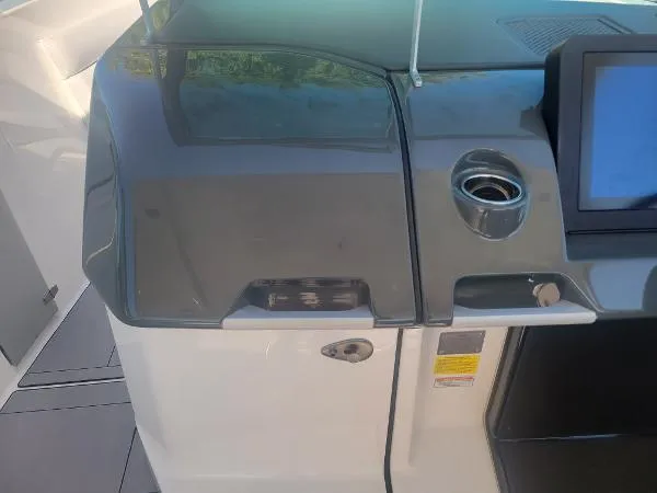 Slide: The Image of 2022 Aviara AV32 OB boat dashboard with touchscreen and cup holder. - 22
