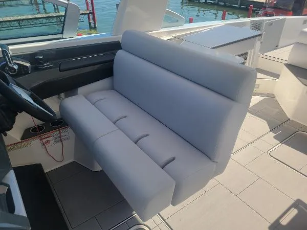 Slide: The Image of 2022 Aviara AV32 OB boat interior with gray seating and helm station. - 23