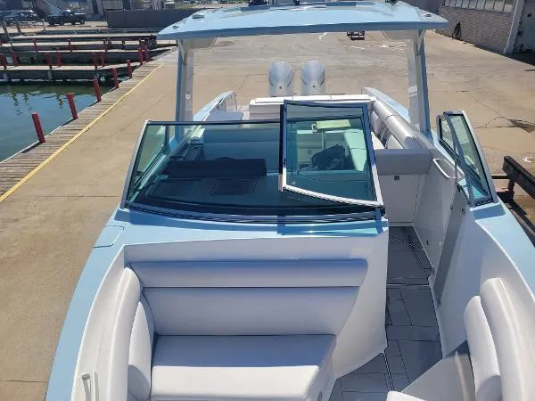 Slide: The Image of 2022 Aviara AV32 OB boat with sleek design and spacious seating at a marina. - 28