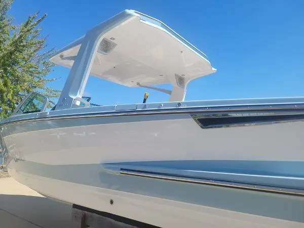 Slide: The Image of 2022 Aviara AV32 OB boat with sleek design and modern features under clear blue sky. - 3