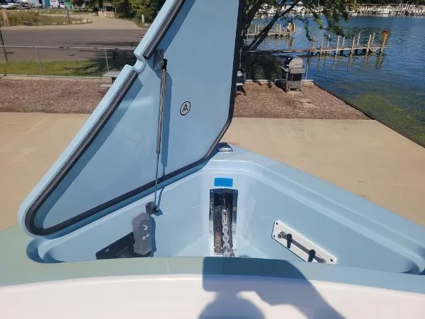 Slide: The Image of Open storage compartment on 2022 Aviara AV32 OB boat by the water. - 31