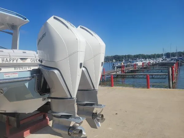 Slide: The Image of Aviara AV32 OB 2022 boat with dual Mercury outboard engines docked by a marina. - 39