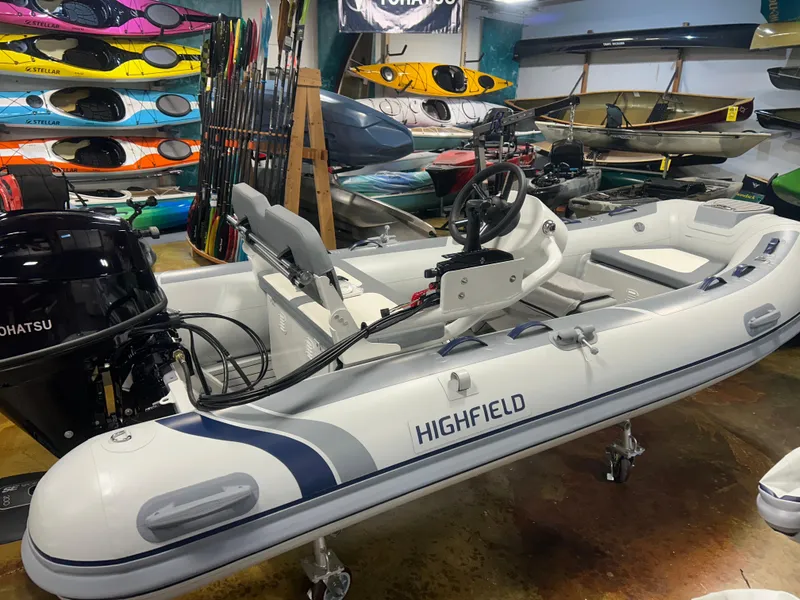 The Image of 2025 Highfield Classic 360 FCT inflatable boat in showroom with kayaks and equipment. - 1