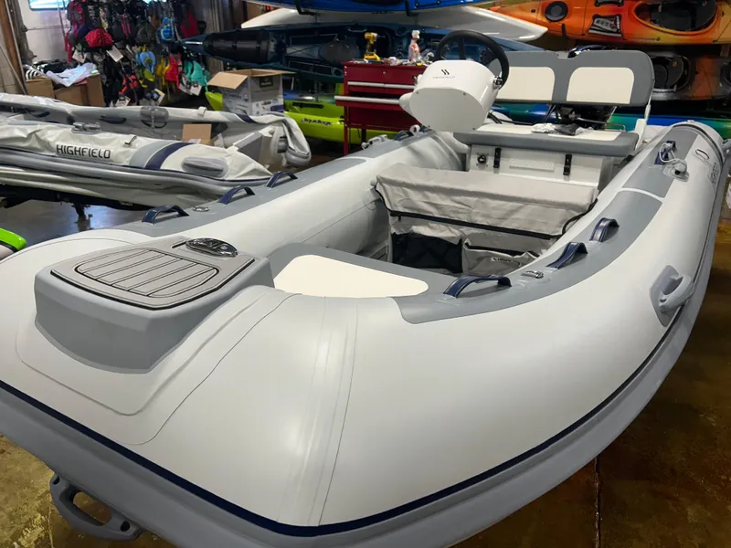 Slide: The Image of 2025 Highfield Classic 360 FCT inflatable boat in showroom, featuring sleek design and modern seating. - 3