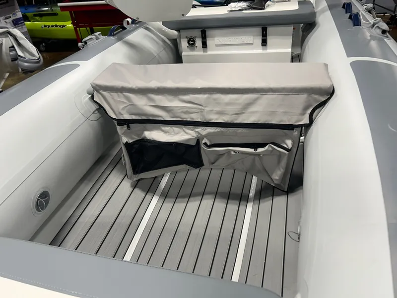 Slide: The Image of 2025 Highfield Classic 360 FCT boat interior with cushioned seating and storage compartments. - 5