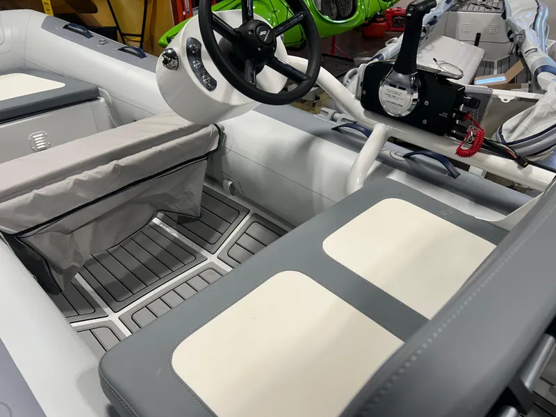 Slide: The Image of 2025 Highfield Classic 360 FCT boat interior with steering wheel and seating. - 6