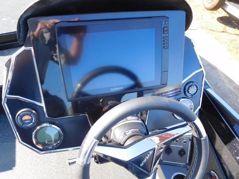Slide: The Image of 2024 Vexus VXS 20 boat dashboard with Garmin display and steering wheel. - 2