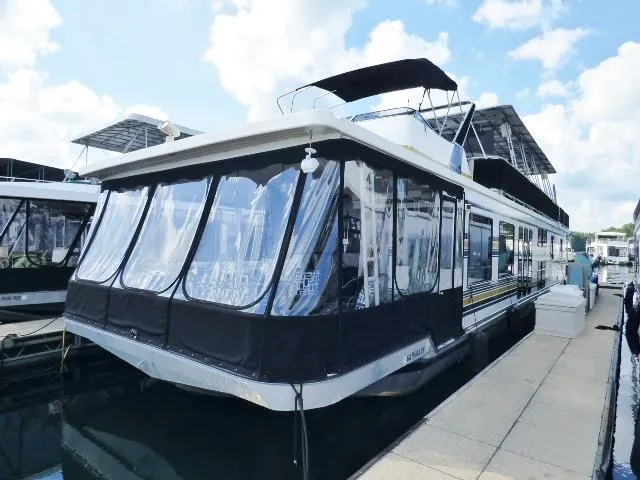 The Image of 1997 Sumerset 16x80 houseboat docked under a clear blue sky. - 0