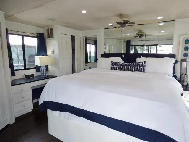 Slide: The Image of Luxurious bedroom in 1997 Sumerset 16x80 houseboat with king bed and elegant decor. - 10