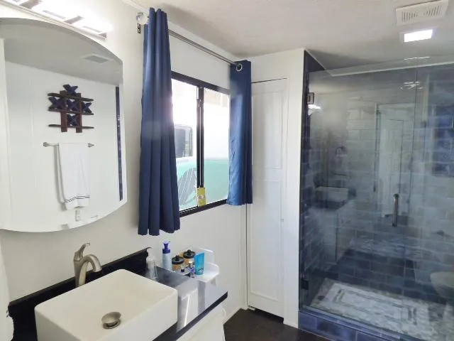 Slide: The Image of Modern bathroom in 1997 Sumerset 16x80 houseboat with glass shower and vessel sink. - 11