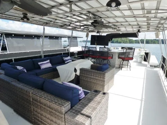 Slide: The Image of Spacious deck of 1997 Sumerset 16x80 houseboat with wicker seating and bar area. - 12