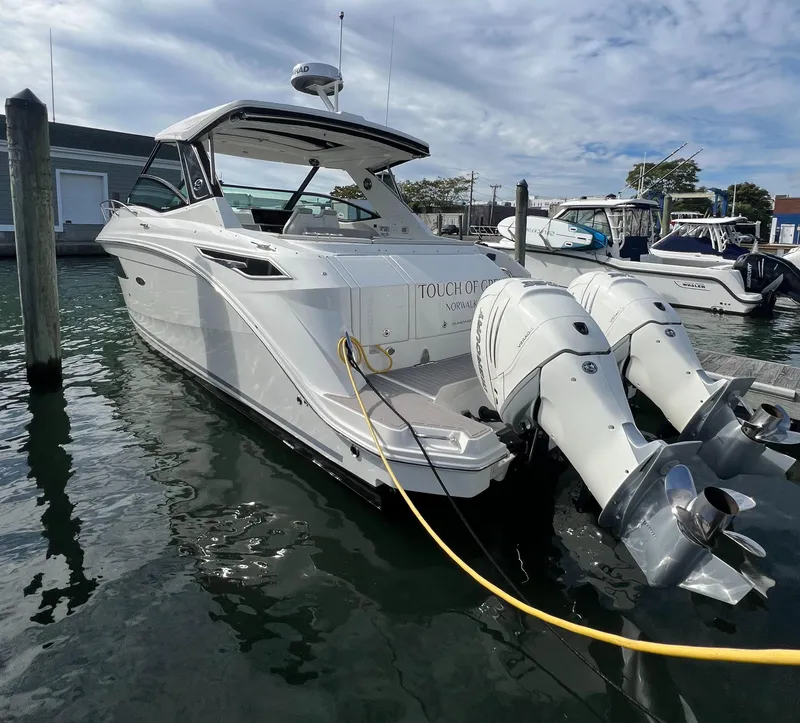 Slide: The Image of 2022 Sea Ray Sundancer 320 OB docked with twin outboard engines. - 10