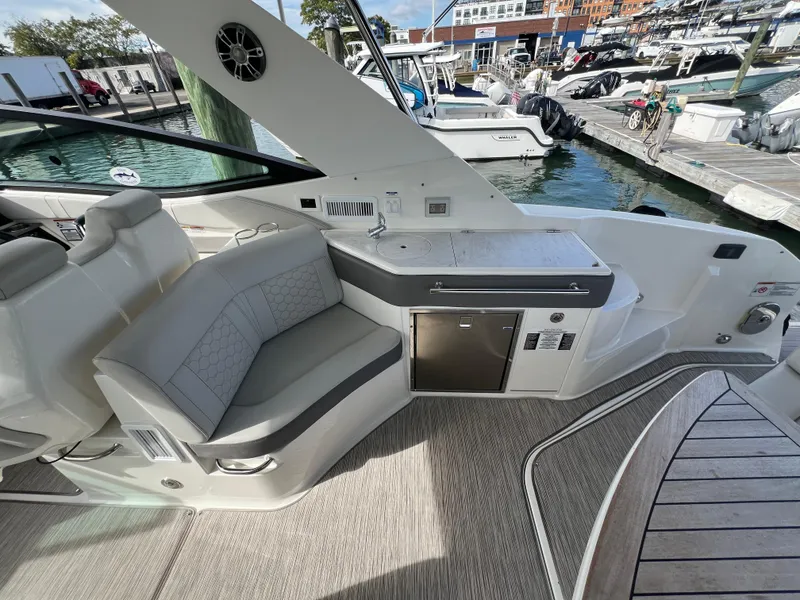 Slide: The Image of 2022 Sea Ray Sundancer 320 OB interior with seating and kitchenette at marina. - 19
