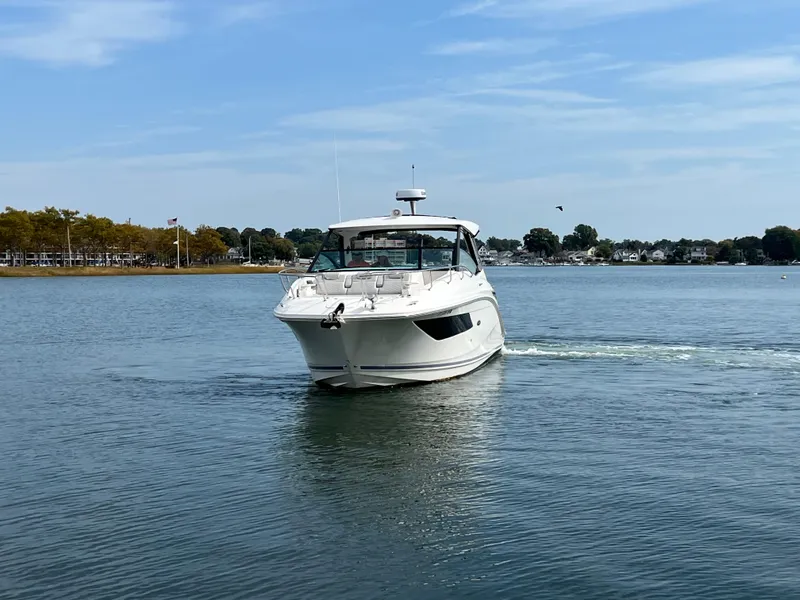 Slide: The Image of 2022 Sea Ray Sundancer 320 OB cruising on a calm lake. - 2