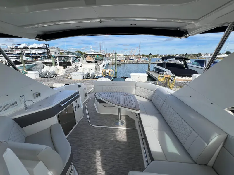 Slide: The Image of 2022 Sea Ray Sundancer 320 OB interior with spacious seating and marina view. - 21