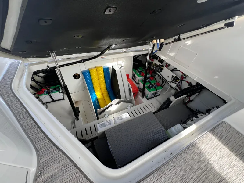 Slide: The Image of 2022 Sea Ray Sundancer 320 OB storage compartment with organized cables and equipment. - 25