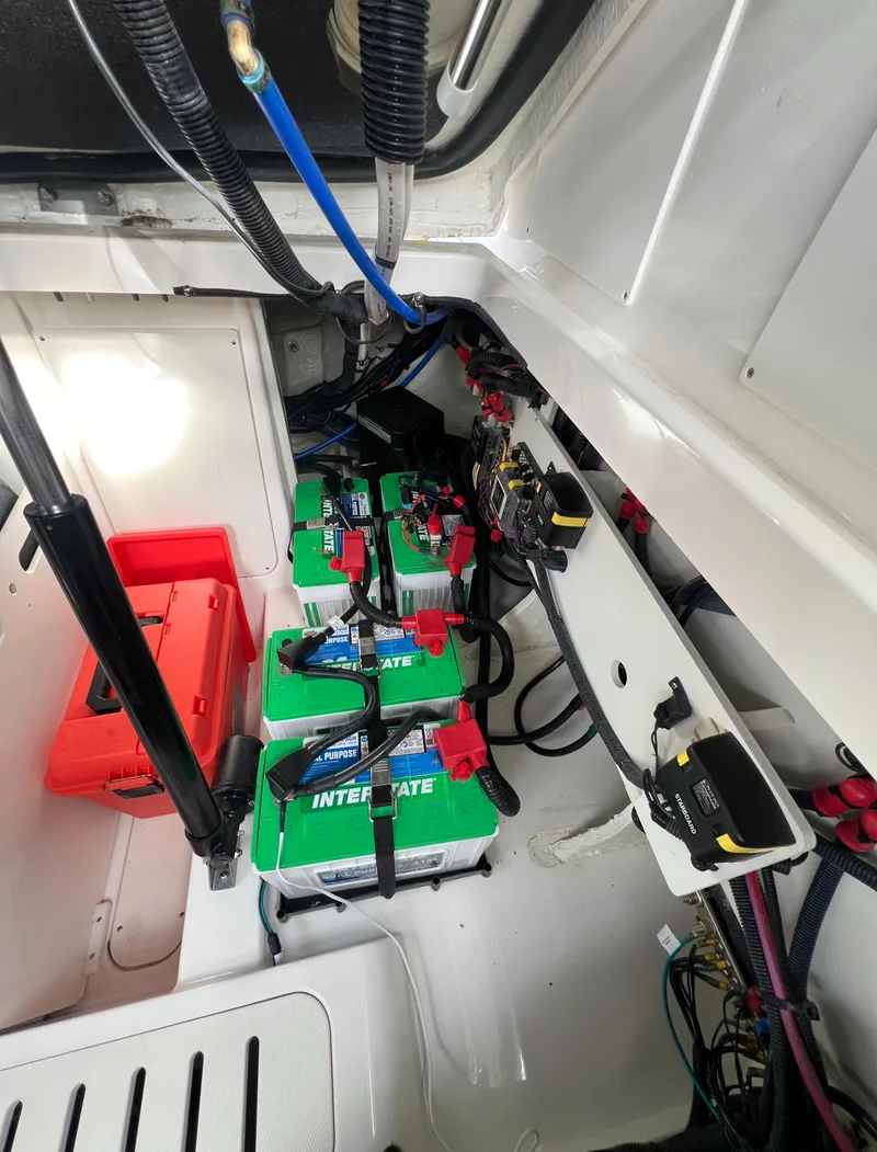 Slide: The Image of 2022 Sea Ray Sundancer 320 OB battery compartment with Interstate batteries and wiring. - 28
