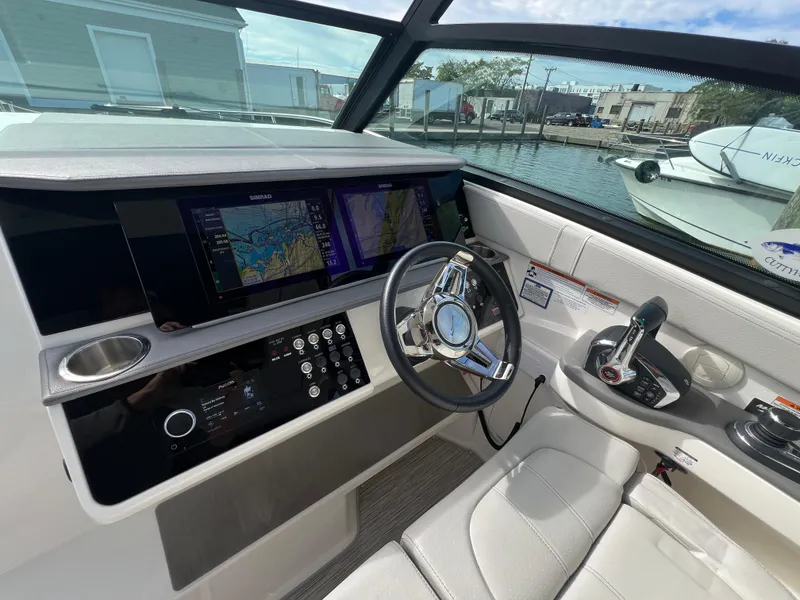 Slide: The Image of Cockpit of 2022 Sea Ray Sundancer 320 OB with modern navigation system and steering wheel. - 33