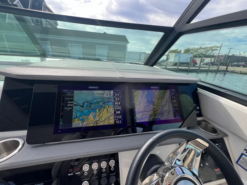 Slide: The Image of Cockpit view of 2022 Sea Ray Sundancer 320 OB with navigation screens. - 34