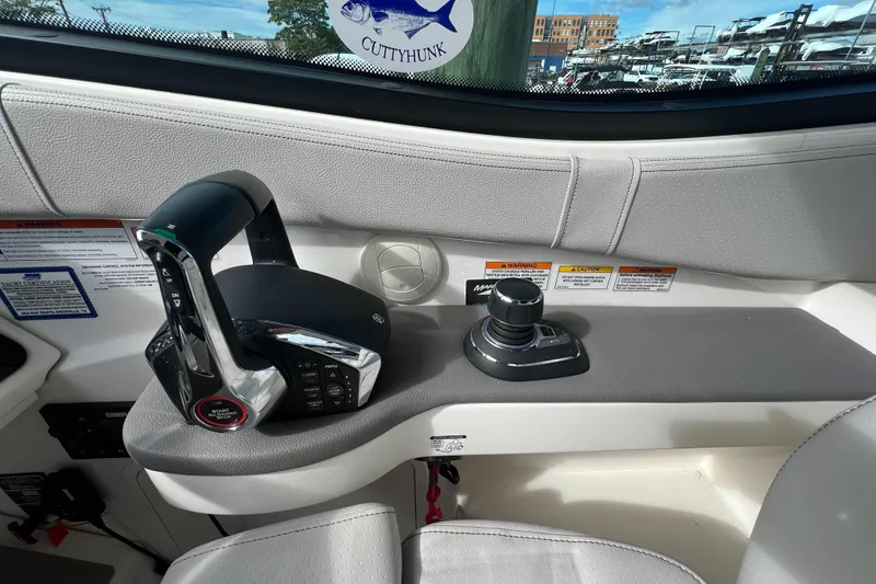 Slide: The Image of 2022 Sea Ray Sundancer 320 OB helm controls with joystick and throttle. - 37