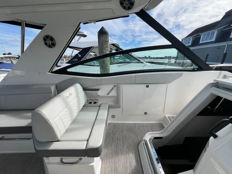 Slide: The Image of 2022 Sea Ray Sundancer 320 OB interior with seating and open cabin entry. - 38